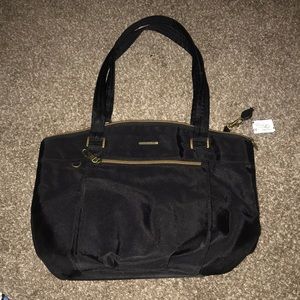 Travelon brand. Nonsmoking. We have dogs.  Has 2 small rings to lock zippers.